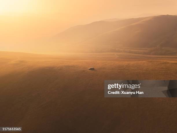 aerial view car driving in the mountains - dirt road landscape sunset stock pictures, royalty-free photos & images