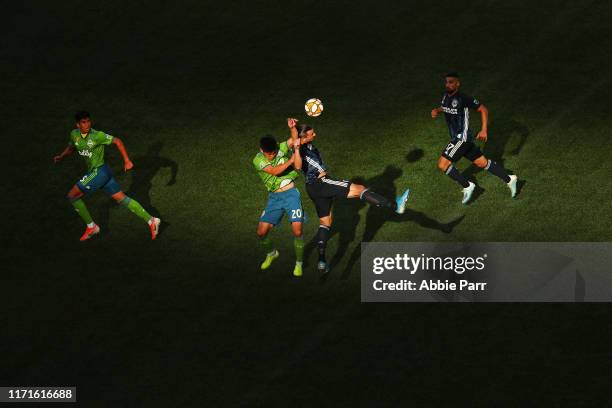 Kim Kee-Hee of the Seattle Sounders and Zlatan Ibrahimovic of the Los Angeles Galaxy jump for the ball in the second half during their game at...