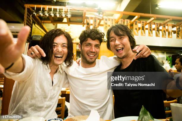 people of various ethnicities interacting at a japanese izakaya - local bar stock pictures, royalty-free photos & images