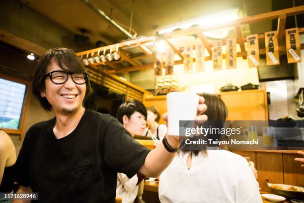 people enjoying at a tavern - 居酒屋 ストックフォトと画像