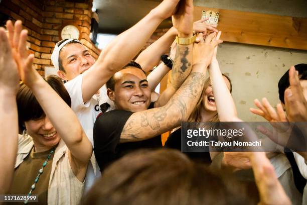people from various countries who get excited at japanese izakayas - local bar stock pictures, royalty-free photos & images