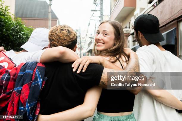 a woman who looks back while crossing shoulder - united ストックフォトと画像