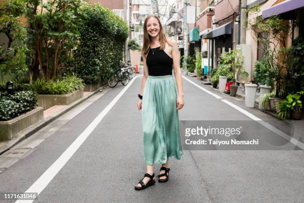 british woman smiling on the streets of tokyo - white shoe fotografías e imágenes de stock