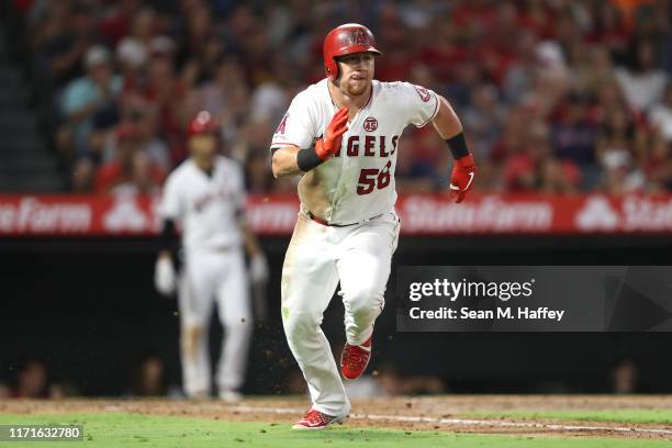 Kole Calhoun of the Los Angeles Angels of Anaheim runs to first base during a game against the Boston Red Sox at Angel Stadium of Anaheim on August...