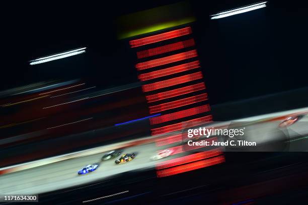 Chase Elliott, driver of the NAPA Throwback Chevrolet, and Brad Keselowski, driver of the Miller Lite Ford, lead a pack of cars during the Monster...