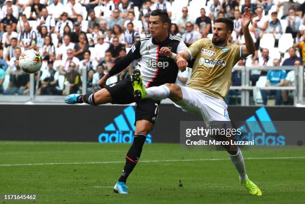 Cristiano Ronaldo of Juventus FC competes for the ball with Nenad Tomovic of SPAL during the Serie A match between Juventus and SPAL at Allianz...