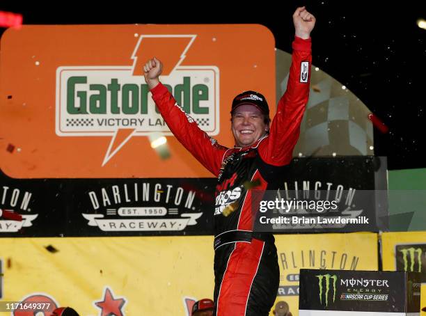 Erik Jones, driver of the Sport Clips Throwback Toyota, celebrates in Victory Lane after winning the Monster Energy NASCAR Cup Series Bojangles'...