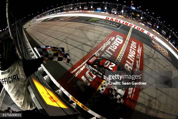 Erik Jones, driver of the Sport Clips Throwback Toyota, takes the checkered flag to win the Monster Energy NASCAR Cup Series Bojangles' Southern 500...