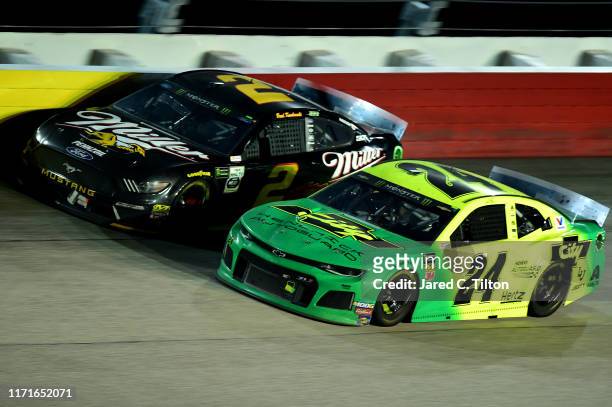 Brad Keselowski, driver of the Miller Lite Ford, races William Byron, driver of the HendrickAutoguard/CityChvrltThrwbck Chev, during the Monster...