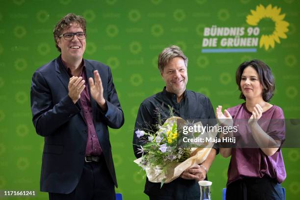 Michael Kellner, secretary general of the German Green Party and German Greens Party leaders Robert Habeck and Annalena Baerbock smile prior a party...