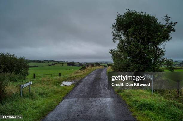 Road runs across the border between Northern Ireland and Ireland on August 29, 2019 near Donegal, Ireland. The 310m/500 km border runs through...