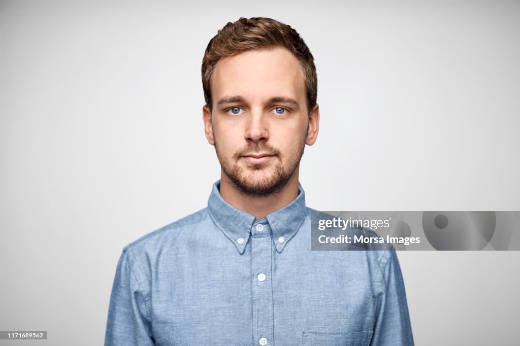 Handsome bearded businessman wearing blue shirt