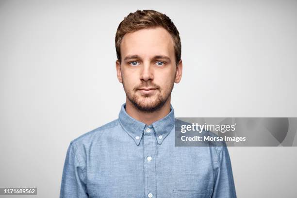 handsome bearded businessman wearing blue shirt - shirt imagens e fotografias de stock