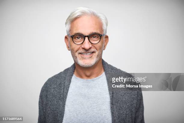senior owner wearing eyeglasses and smart casuals - grey jacket stockfoto's en -beelden
