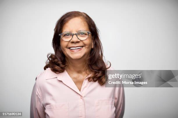 portrait of smiling mature businesswoman - indian old woman stock-fotos und bilder