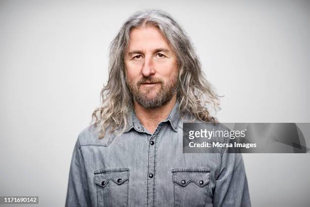 portrait of mature businessman wearing denim shirt - long hair stock pictures, royalty-free photos & images