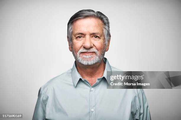 Confident working senior against white background