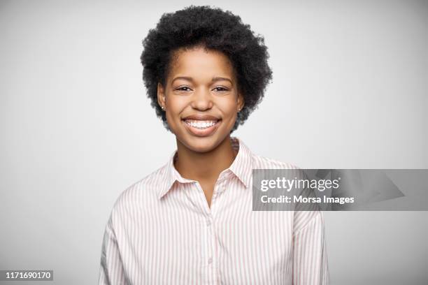 portrait of afro owner wearing striped shirt - african american young woman portrait white background stock-fotos und bilder