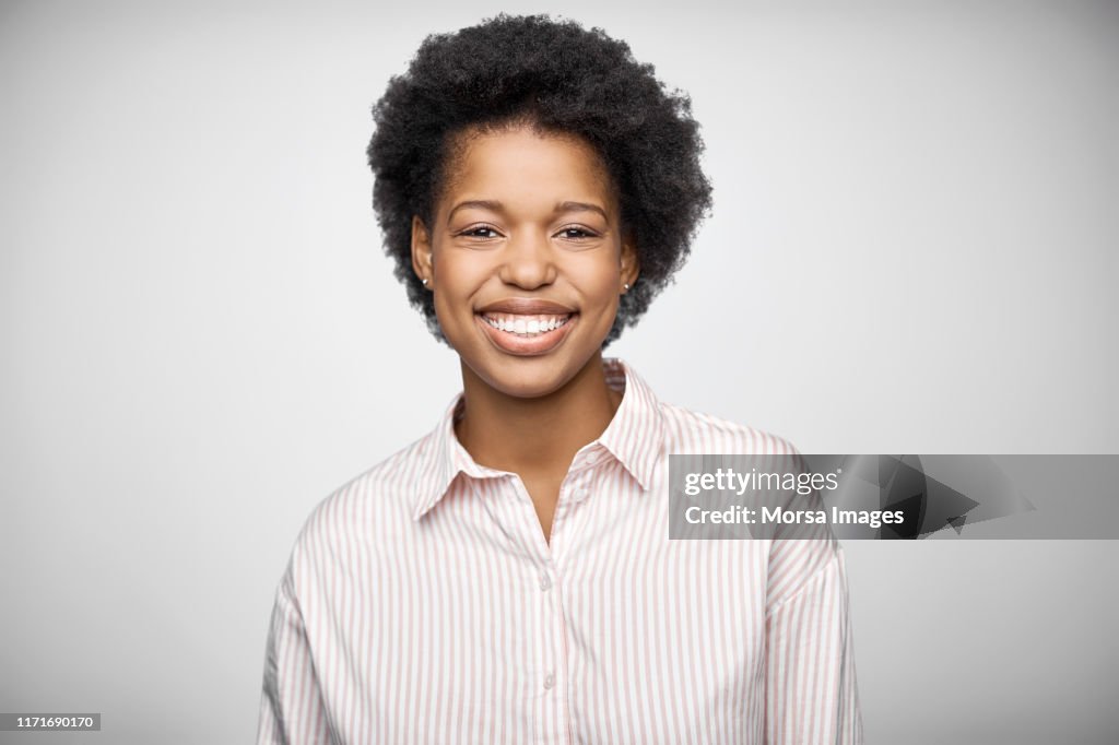 Portrait of afro owner wearing striped shirt