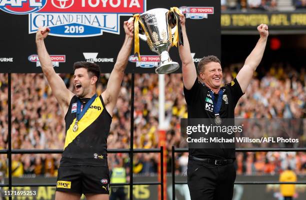 Trent Cotchin of the Tigers and Damien Hardwick, Senior Coach of the Tigers celebrate with the Premiership Cup during the 2019 Toyota AFL Grand Final...