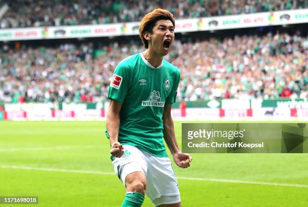 Yuya Osako of Werder Bremen celebrates after scoring his sides third goal during the Bundesliga match between SV Werder Bremen and FC Augsburg at...