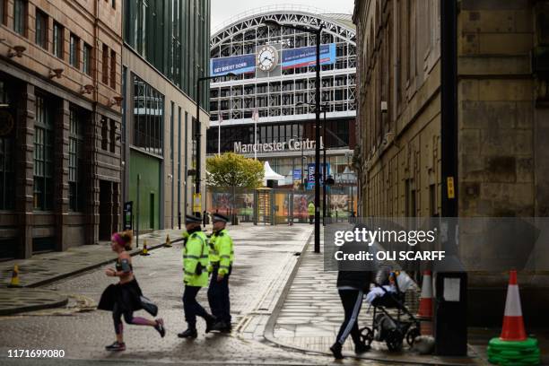 Police patrol outside the Manchester Central convention centre, the venue of the annual Conservative Party conference, in Manchester, northwest...