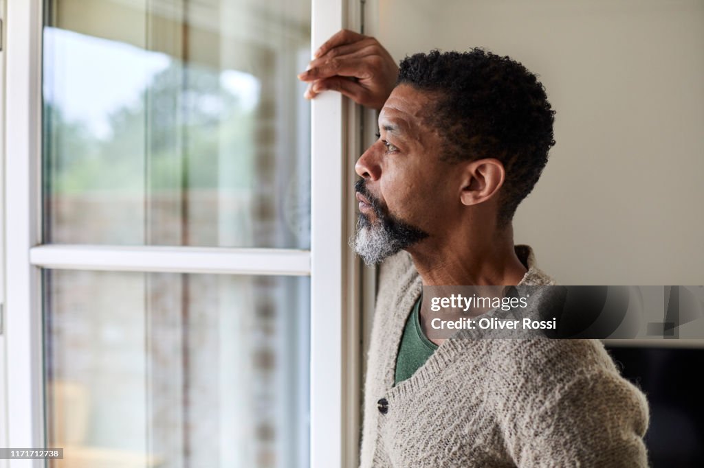Pensive man looking out of window