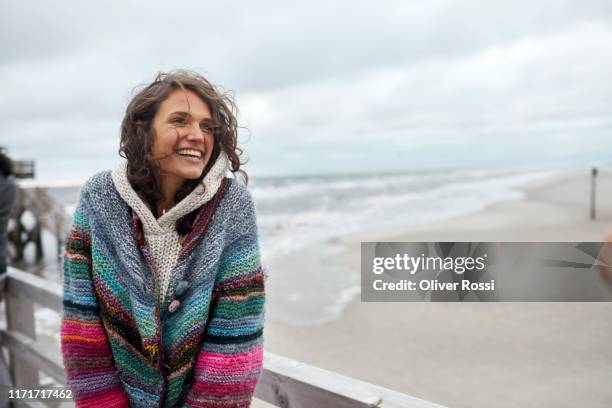 happy woman by the sea - overcast portrait stock pictures, royalty-free photos & images