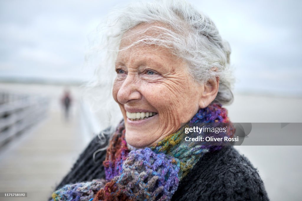 Portrait of happy senior woman by the sea