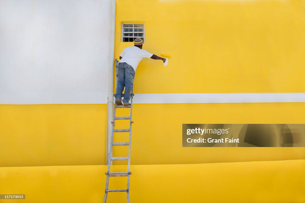 Man painting a house.