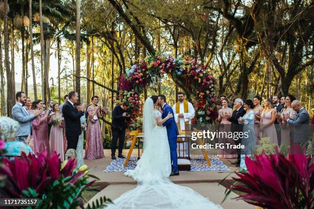 bride and groom in the altar - outdoor wedding stock pictures, royalty-free photos & images