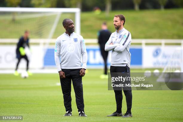 Manager Gareth Southgate stands with coach Chris Powell during an England Media Access day at St Georges Park on September 02, 2019 in...