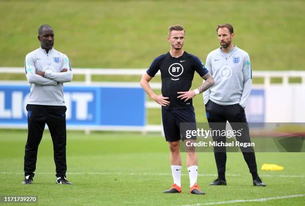 Coach, Chris Powell and England Manager Gareth Southgate watch James Maddison train during an England Media Access day at St Georges Park on...