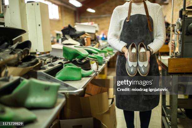 unrecognizable woman holding elegant model of oxford shoes - footwear manufacturing stock pictures, royalty-free photos & images