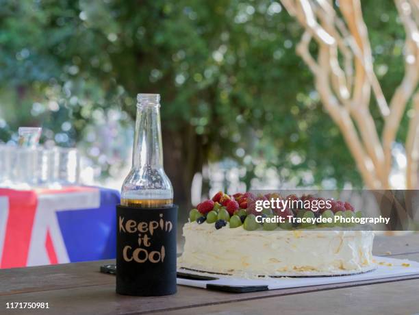 pavlova and a cold drink prepared for an australian barbecue. - australia day bbq stock pictures, royalty-free photos & images