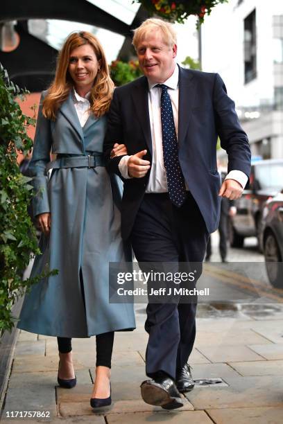 British Prime Minister Boris Johnson and his girlfriend Carrie Symonds arrive at the Conservative Party Conference on September 28, 2019 in...