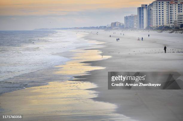 incidental people at jacksonville beach during sunset. florida, usa - jacksonville beach stock pictures, royalty-free photos & images