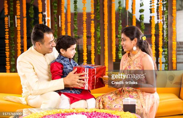 indian family celebrating raksha bandhan - raksha bandhan stock pictures, royalty-free photos & images