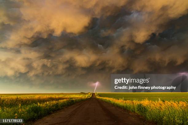 a lightning bolt on a stunning storm at sunset, nebraska. usa - kansas landscape stock pictures, royalty-free photos & images