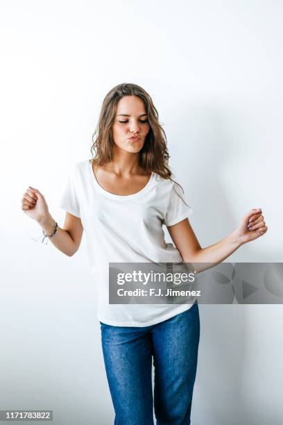 portrait of woman dancing - frau jeans stock-fotos und bilder