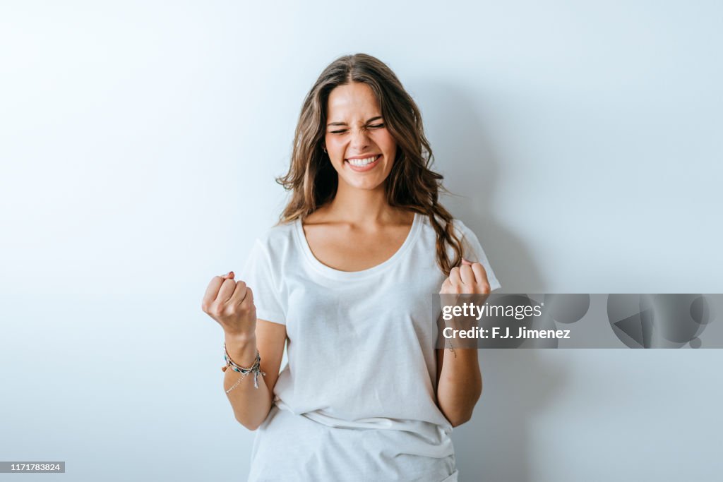 Portrait of woman with triumph gesture