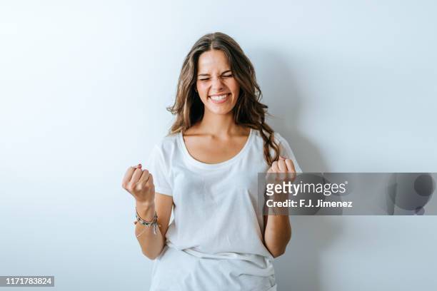 portrait of woman with triumph gesture - successo foto e immagini stock