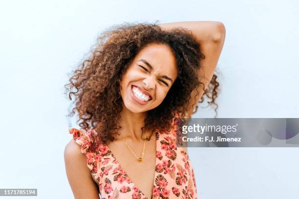 portrait of smiling woman - afro hairstyle stock-fotos und bilder