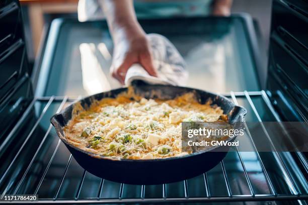 preparing frittata with green asparagus, peas and parmesan - frittata stock pictures, royalty-free photos & images