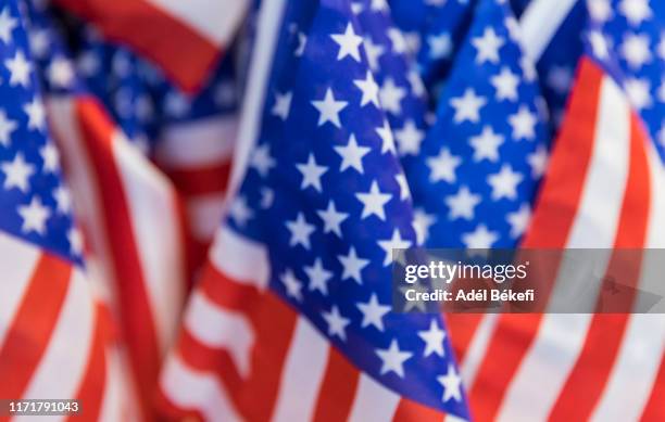 defocused  images of american flags - american flag banner stock pictures, royalty-free photos & images