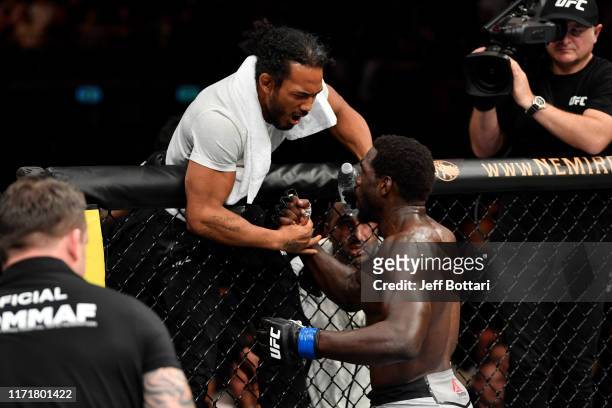 Jared Cannonier celebrates his TKO victory with his cornerman Benson Henderson after his middleweight bout during the UFC Fight Night event at Royal...