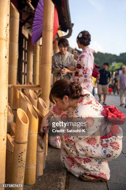 event staff in yukata igniting candles - offspring culture tourism festival stock pictures, royalty-free photos & images