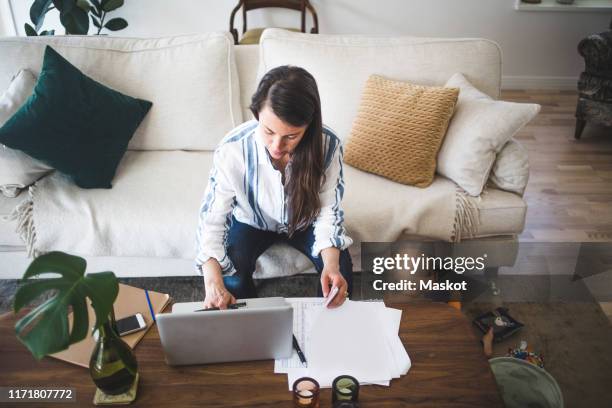 high angle view of female entrepreneur concentrating on work while daughter playing at home office - computer work life balance stockfoto's en -beelden