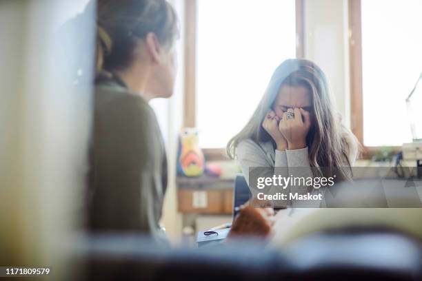 displeased teenage girl talking to therapist at wellness center - old lady crying out for help stock pictures, royalty-free photos & images