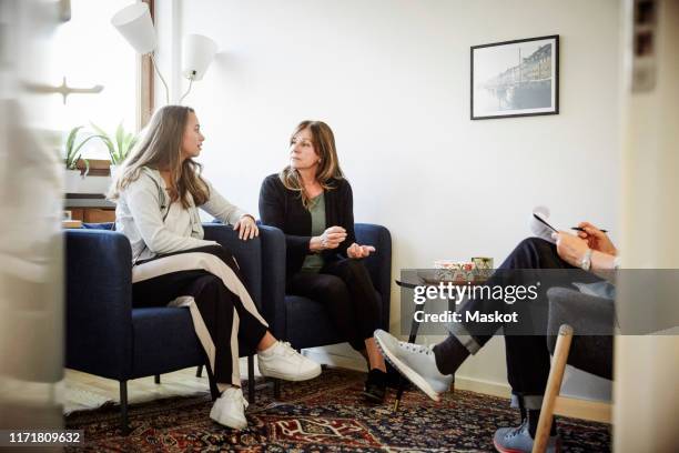 daughter arguing with her mother during therapy session at workshop - fighting group stock pictures, royalty-free photos & images